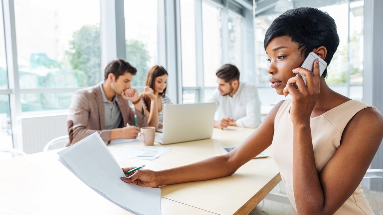 serious-businesswoman-with-documents-talking-on-P9Q6LX6-1400x788