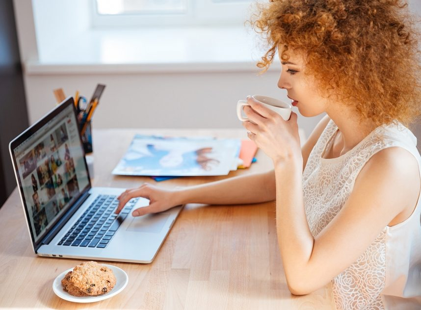 woman-photographer-drinking-coffee-and-working-PJNBP6U-858x632